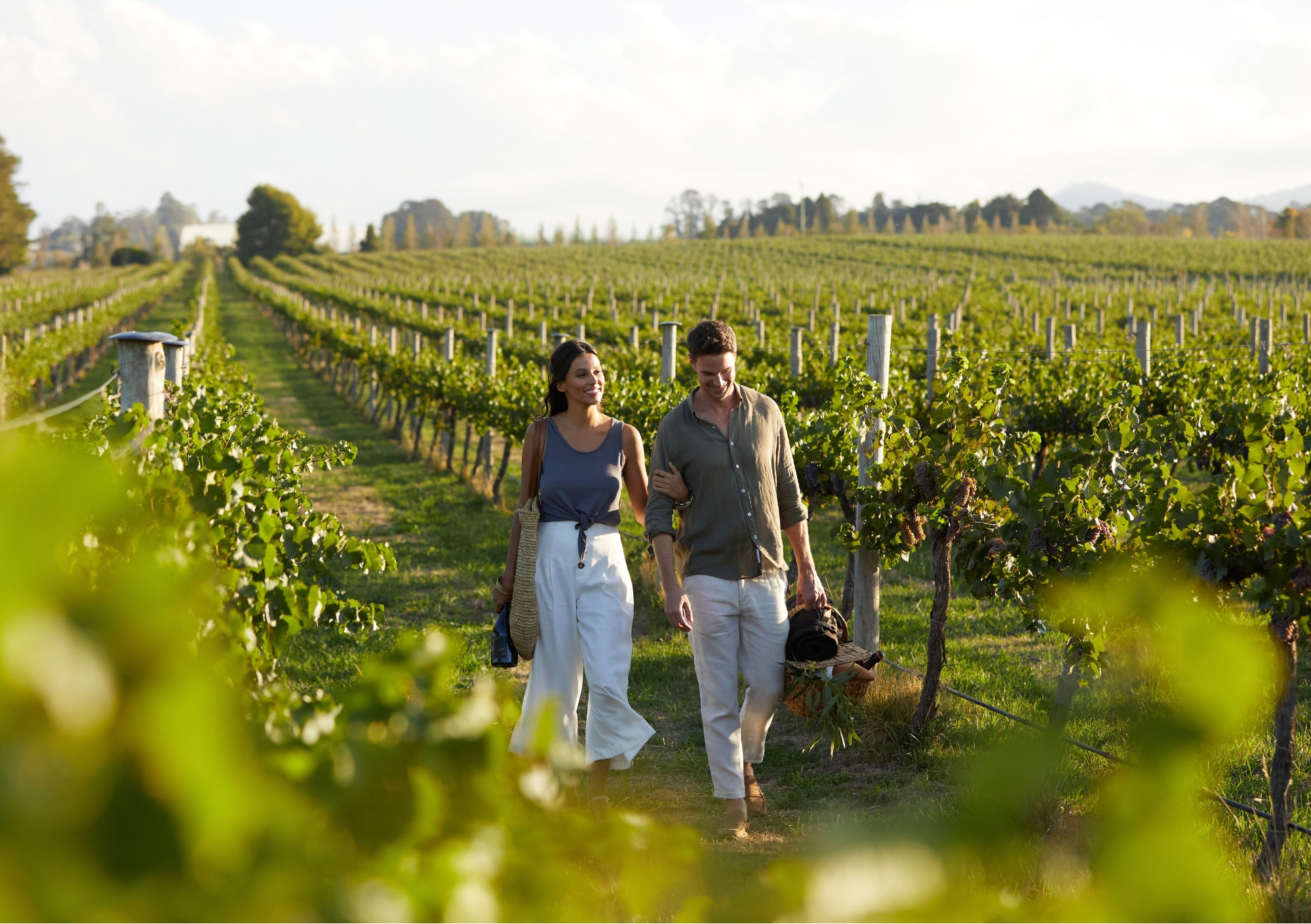 a couple taking a stroll through vineyards in orange nsw