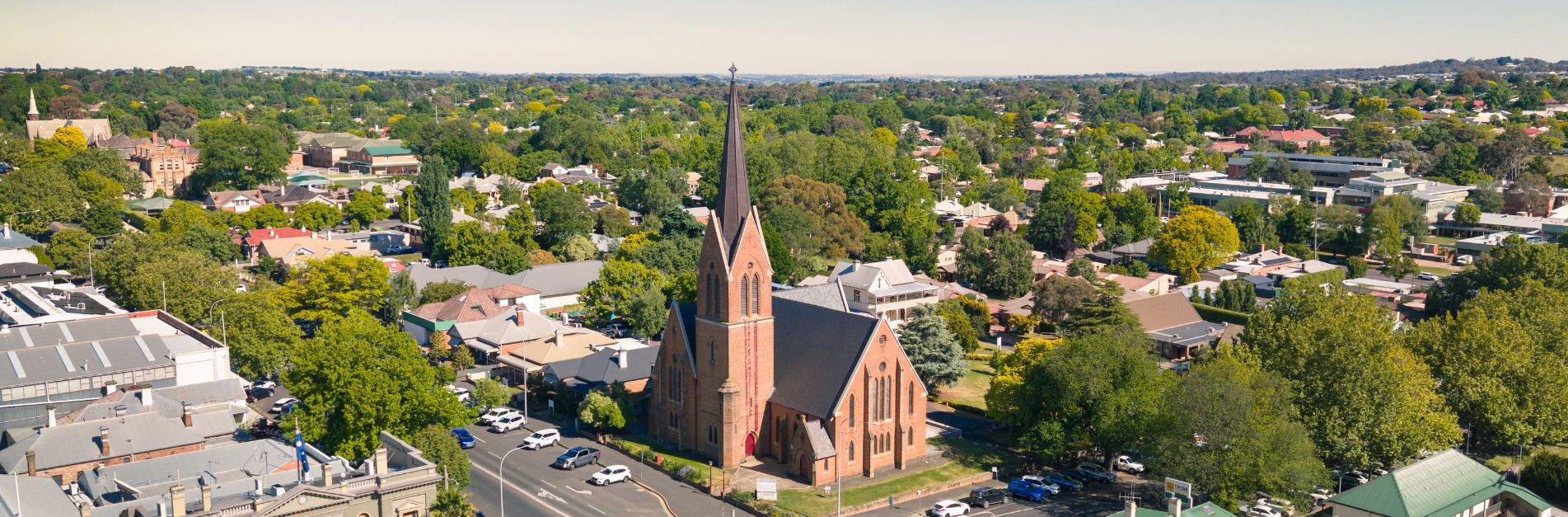 Aerial View of Orange NSW Aerial view of Orange NSW featuring historic church architecture, tree-lined streets, and the vibrant regional city surrounded by gardens and heritage buildings.