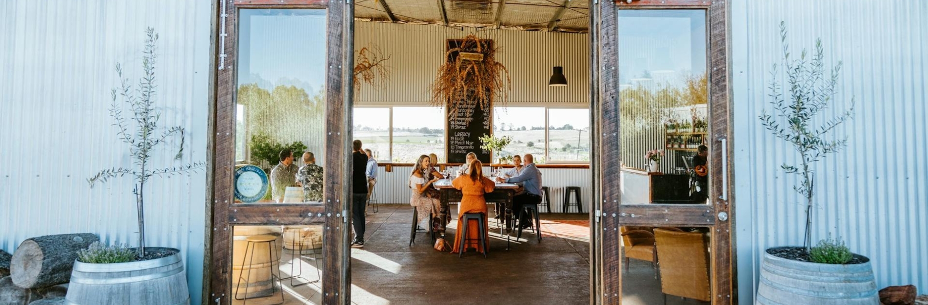 nashdale winery orange nsw Guests enjoying wine tasting at Nashdale Lane Wines in Orange, NSW, inside the modern cellar door overlooking rolling vineyards and countryside views.