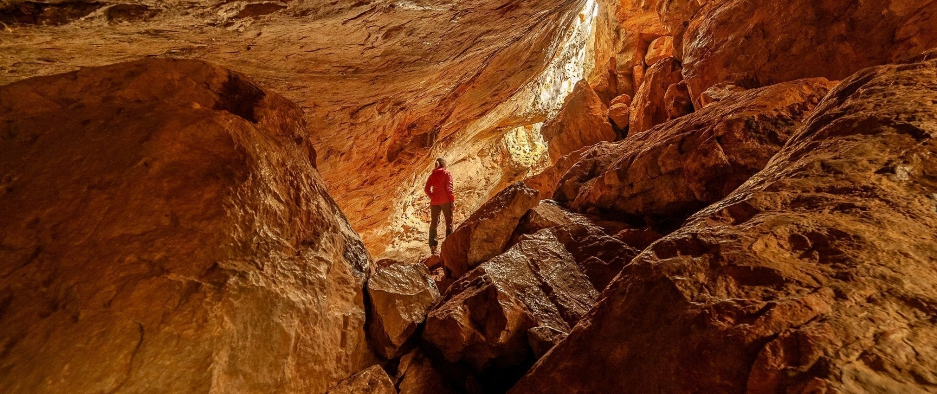 Person exploring the rocky interior of Borenore Caves near Orange NSW