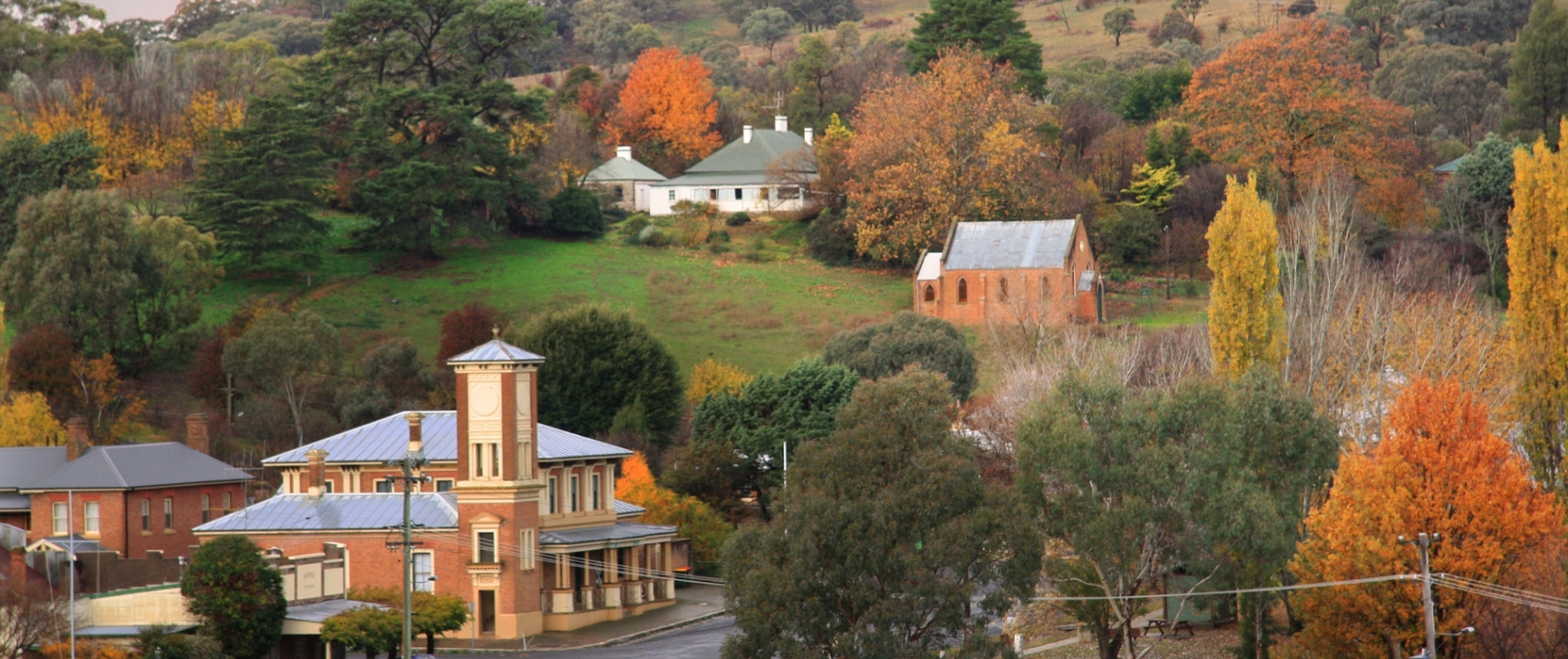 Historic buildings surrounded by autumn foliage in the village of Carcoar NSW